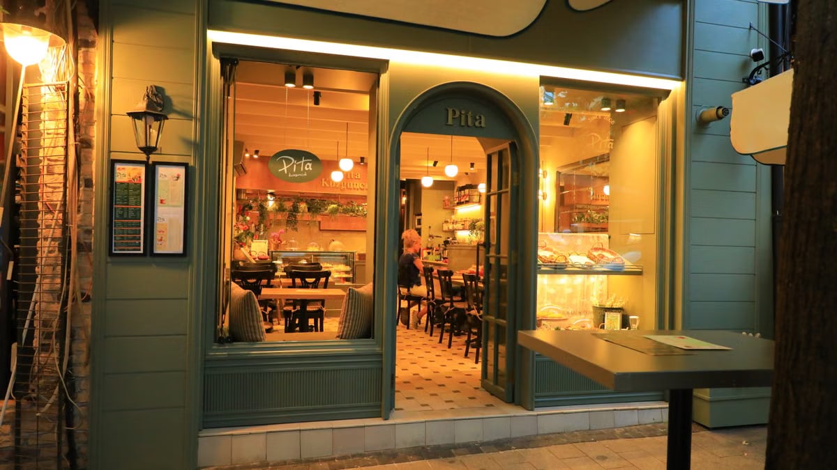 Warm evening shot of a welcoming pita restaurant entrance showcasing a charming atmosphere.